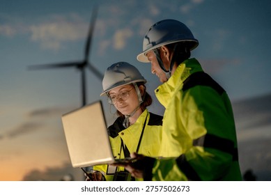 Green collar workforce using advanced tech to manage sustainable wind power. Visionary engineers committed to global ESG goals and carbon neutrality.