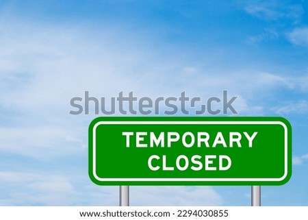 Green color transportation sign with word temporary closed on blue sky with white cloud background