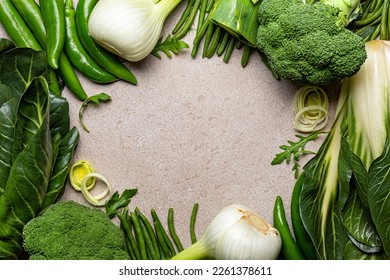 Green colour vegetables frame, food background with text box. Swiss Chard, broccoli, green beans, fennel, peppers, leek. Healthy eating concept of fresh garden product.