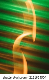 Green Corrugated Metal Background With Orange Light Trail. St Patrick's Day Abstract Background.