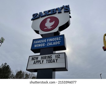 Green County, Ga USA - 12 20 21: Zaxbys Restaurant Now Hiring Message On A Street Sign