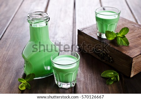 Green creamy liquid in a glass. Selective focus.