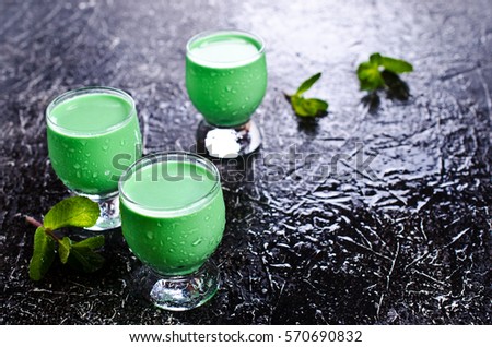 Green creamy liquid in a glass. Selective focus.