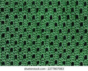 Green crochet pattern. Simple knitting mesh pattern. Net knitted background.