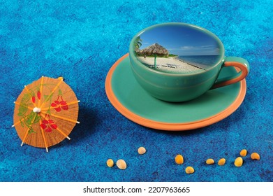 Green Cup With Beach Scene From Cuba. Drink Umbrella And Tiny Yellow Sesnail Shells.