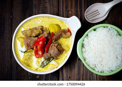 Green Curry beef with rice and Rice Noodles on wood table, Thai food