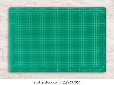 Green Cutting Mat On Wood Texture Background With Clipping Path.