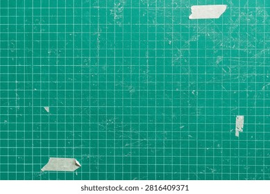 Green Cutting Mat Texture Background with Grid Lines and Torn Masking Tape
