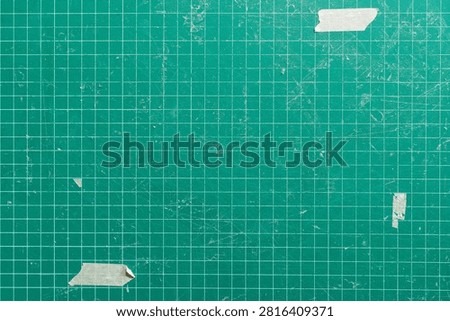 Green Cutting Mat Texture Background with Grid Lines and Torn Masking Tape