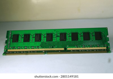 Green DDR3 RAM memory module with integrated circuits and gold contact pins. Computer hardware component, PC memory, circuit board, motherboard component, technology hardware, isolated on white background, close up detail.