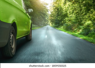 Green Delivery Van Driving Through A Forest