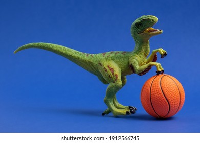 Green Dinosaur Toy With Basketball Ball. Basketball Minimal Card Blue Background.