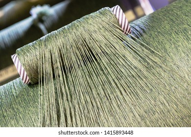 Green Dirty Dark Brown Cotton Wool Threads In A Factory Industrial For Production Of Clothes Materials Yarn Individual Threads Coming Together On A Drum Tube Pipe 