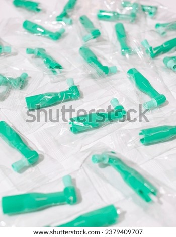 Green Disposable Prophy Angles with Brush, Ergonomic Shape on White Background. Dentistry, Orthodontic Product. Vertical Plane. Oral Hygiene. High quality photo