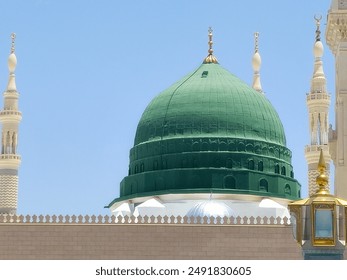 The Green dome of The Prophet's Mosque or Al Masjid Al Nabawi, a major site of pilgrimage that falls under the purview of the Custodian of the Two Holy Mosques - Powered by Shutterstock