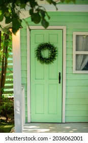 Green Door And Decorative Wreath. Autumn Welcome Wreath, Decorating Front Door Home. House Door With Decor With Leaves Wreath. Autumn Cozy Decor Home For Thanksgiving. Summer Decor Door 