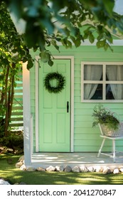 Green Door And Decorative Wreath. Autumn Welcome Wreath, Decorating Front Door Home. House Door With Decor With Leaves Wreath. Autumn Cozy Decor Home For Thanksgiving. Summer Decor Door	