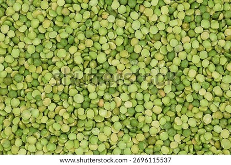 Green, dry split peas background in top view.