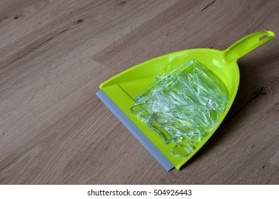 Green Dustpan With Broken Glass