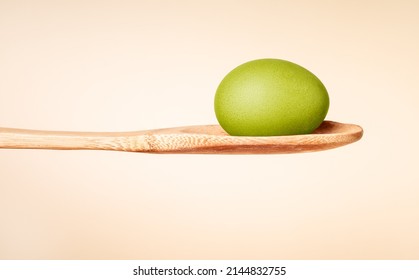 Green Dyed Easter Egg In Wooden Spoon. Religious Holiday Celebration Tradition. Cooking And Painting Process. High Quality Photo