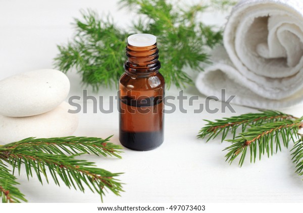Green eco cosmetics
spa treatment. Essential oil, aromatic pine twigs, white towels.
Relaxing beauty care.
