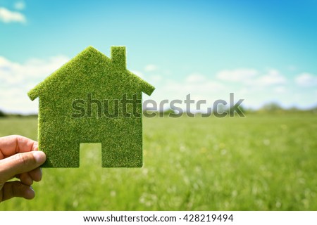 Green eco house environmental background in field for future residential building plot
