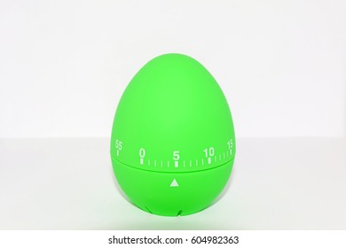 Green egg timer in front of white background - isolated