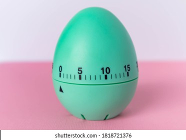 Green Egg Timer On Pink Background. Happy Easter In The Kitchen. Home Related, Home Staying. Free Copy Space. Flat Lay, Top View.