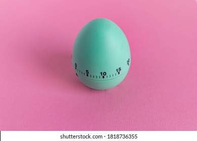 Green Egg Timer On Pink Background. Happy Easter In The Kitchen. Home Related, Home Staying. Free Copy Space. Flat Lay, Top View.