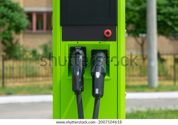 Green electric car charging at power
station. Eco-friendly filling station for eco
car