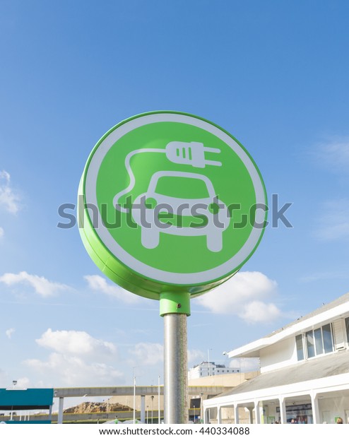 green electric car charging station symbol in\
Brighton, UK