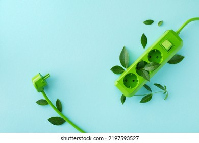 Green electric power socket with fresh leaves top view. Renewable and saving energy, eco or green power consumption concept. - Shutterstock ID 2197593527