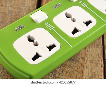 green electric socket on the wood background. Close up. - Shutterstock ID 428055877