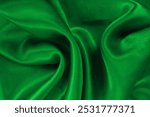 Green emerald fabric texture background, detail of silk or linen pattern.