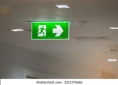 Green Emergency Exit Sign In Hospital Showing The Way To Escape
