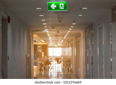 Green Emergency Exit Sign In Hospital Showing The Way To Escape
