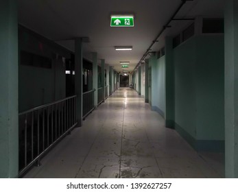 Green Emergency Exit Sign In Hospital Showing The Way To Escape At Night
