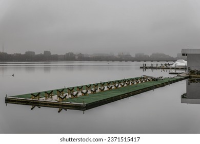 A green empty dock on a foggy day. - Powered by Shutterstock