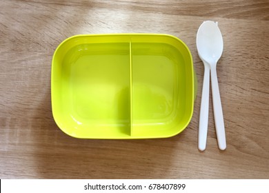 Green Empty Lunch Box Wrapped  On Wooden Table , Top View Or Overhead Shot , Green Food Concept