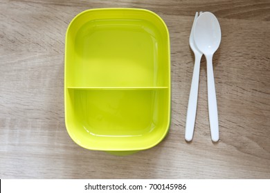 Green Empty Lunch Box Wrapped  On Wooden Table , Top View Or Overhead Shot , Green Food Concept