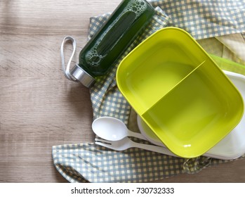 Green Empty Lunch Box Wrapped  On Wooden Table , Top View Or Overhead Shot , Green Food Concept