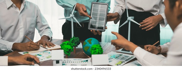 Green energy business company meeting with business people planning and discuss marketing of sustainable and renewable clean energy product with solar cell and wind turbine generator. Trailblazing - Powered by Shutterstock