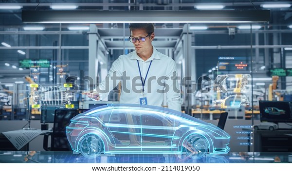 Green Energy Car Design: Automotive\
Engineer Using Augmented Reality Hologram to Construct 3D Model of\
High-Tech Electric Vehicle Optimizing Battery Efficiency. Automated\
Robot Arm Manufacturing