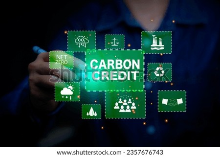 Green energy, Carbon credit market concept. Businessman pointing Carbon credit icon. Net zero in 2050 year. Green energy icon around it. Carbon Neutral in industry Net zero emission eco energy.