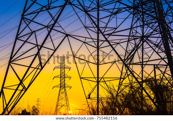 Green\
energy concept, Electricity station, Close up high voltage power\
lines at sunset. electricity distribution station. high voltage\
electric transmission pylon silhouetted \
tower.