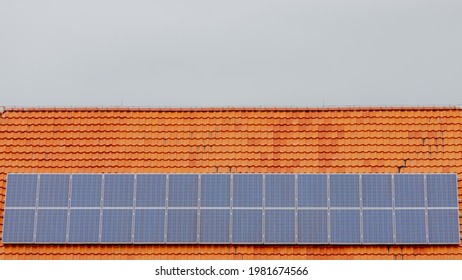 Green Energy Concept, A Solar Cell On A Bricks Rooftop Of The House, Photovoltaic Cell Is An Electrical Device That Converts The Energy Of Light Directly Into Electricity By The Photovoltaic Effect.