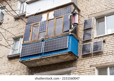 Green energy from solar panels on the balcony in a high-rise building gives free electricity to a separate apartment and save money. - Shutterstock ID 2151560047