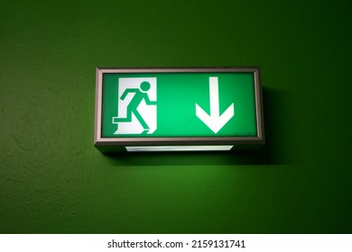 A Green Escape Route Sign On A Green Background