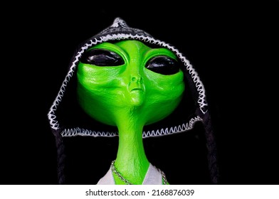 Green Extraterrestrial Figure Dressed As Trickster On Black Background
