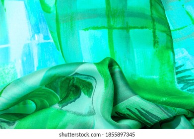 green fabric with abstract pattern, print of branches with flora leaves. Background texture. luxurious satin fabric texture. Background. Template.
